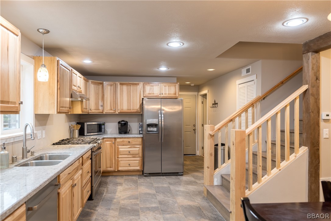 270 Spruce Lane Sugarloaf, CA 92386 - Photo 17 of 39 a kitchen with a sink stainless steel appliances cabinets and a large window