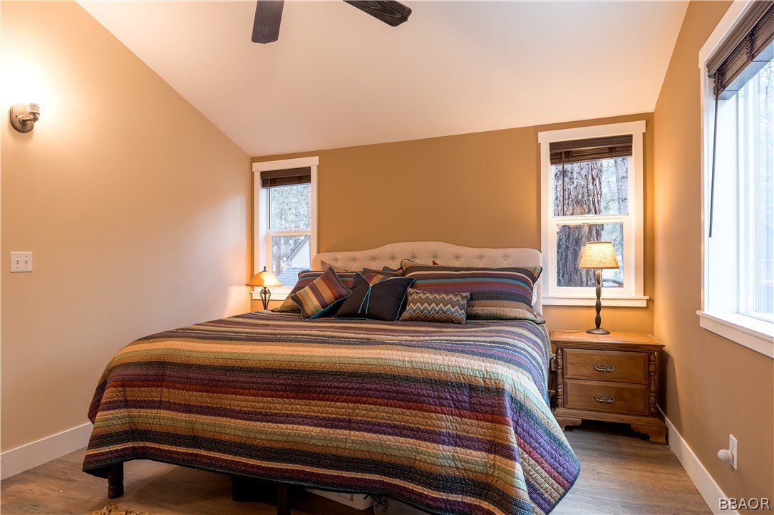 270 Spruce Lane Sugarloaf, CA 92386 - Photo 21 of 39 a bedroom with a bed and windows