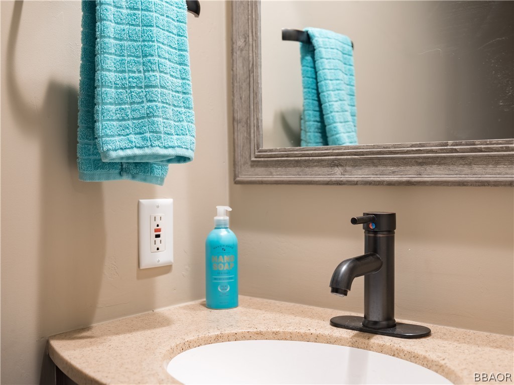 270 Spruce Lane Sugarloaf, CA 92386 - Photo 31 of 39 a bathroom with a sink and a mirror