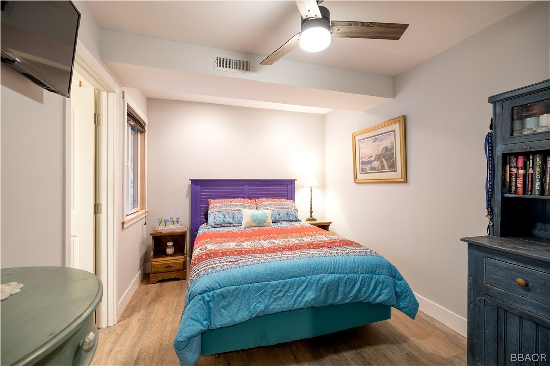 270 Spruce Lane Sugarloaf, CA 92386 - Photo 32 of 39 a bedroom with a bed and a flat screen tv