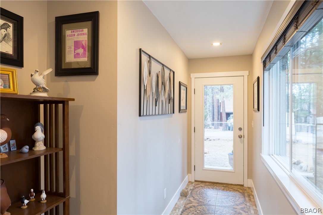 270 Spruce Lane Sugarloaf, CA 92386 - Photo 5 of 39 a view of a hallway with wooden floor and windows