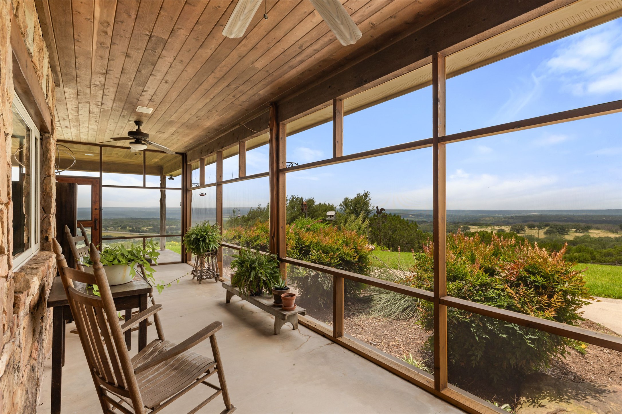 8400 Ranch Road 1431 Marble Falls, TX 78654 - Photo 3 of 30 A spacious screened-in porch with a wood ceiling offers commanding views of the sprawling landscape.