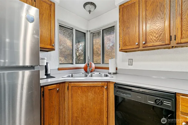 a kitchen with stainless steel appliances granite countertop a refrigerator and a sink