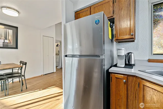 a kitchen with stainless steel appliances granite countertop a refrigerator and a sink