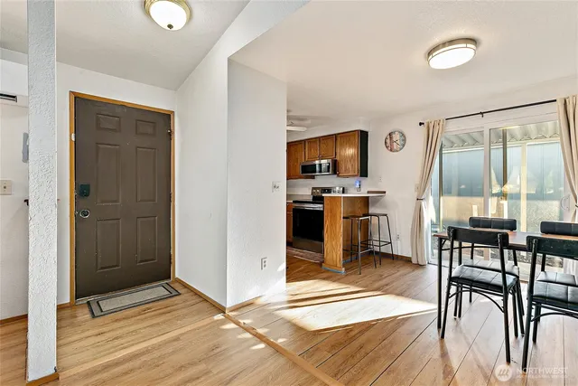 a view of a livingroom with wooden floor and furniture