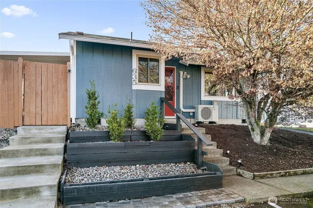 a front view of a house with lots of potted plants
