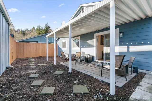 a view of a patio with table and chairs near a barn