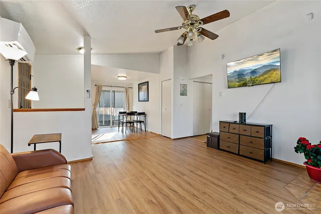 a living room with furniture and a wooden floor