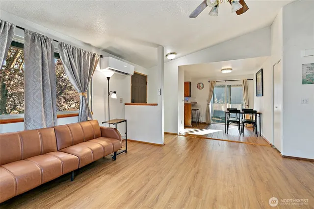 a living room with furniture and a wooden floor