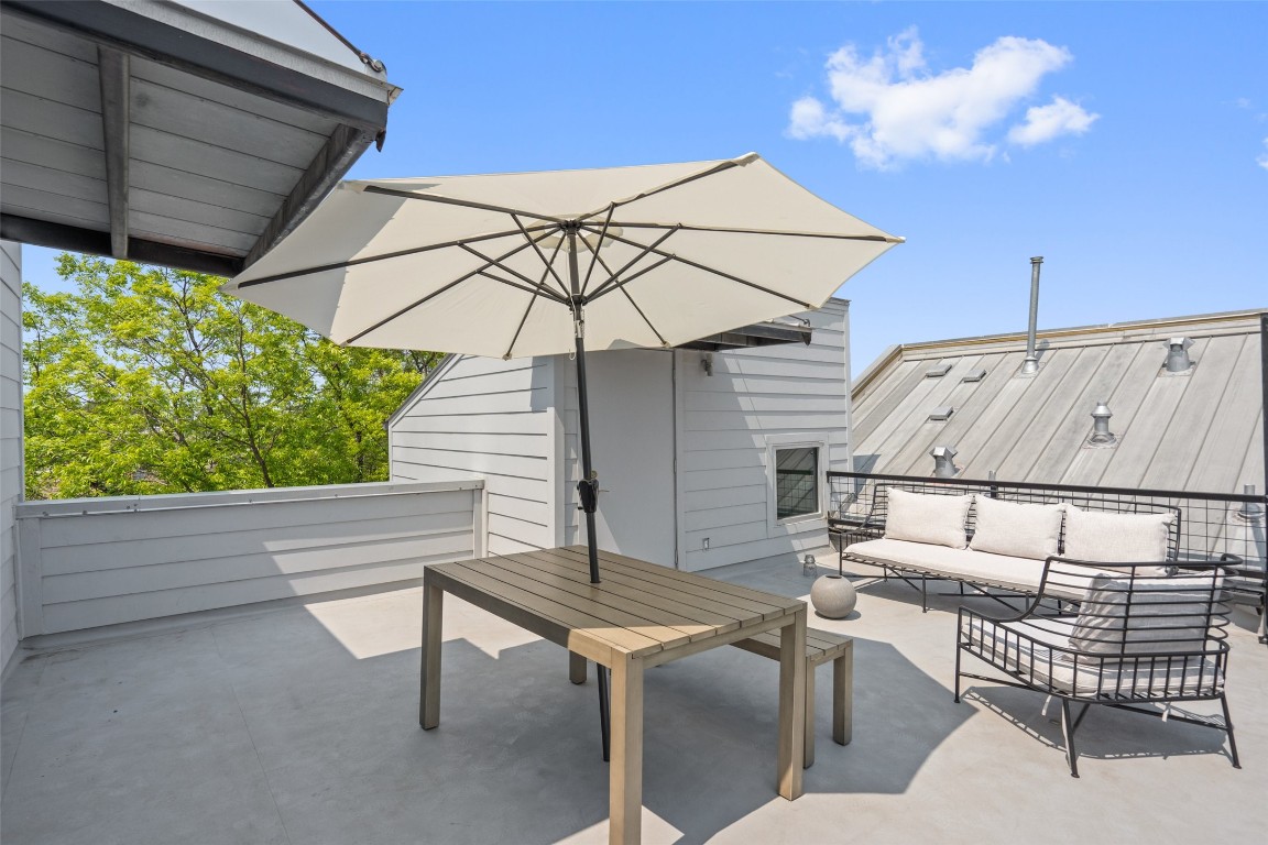 1500 Summit Street, Unit 5 Austin, TX 78741 - Photo 34 of 38 a view of a patio with a table and chairs under an umbrella