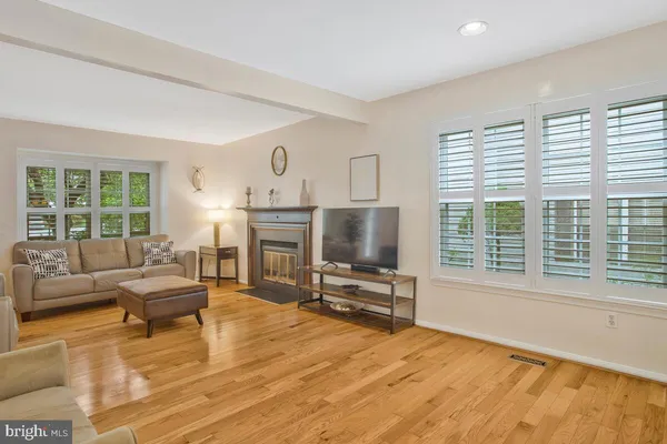 a living room with furniture a large window and a flat screen tv