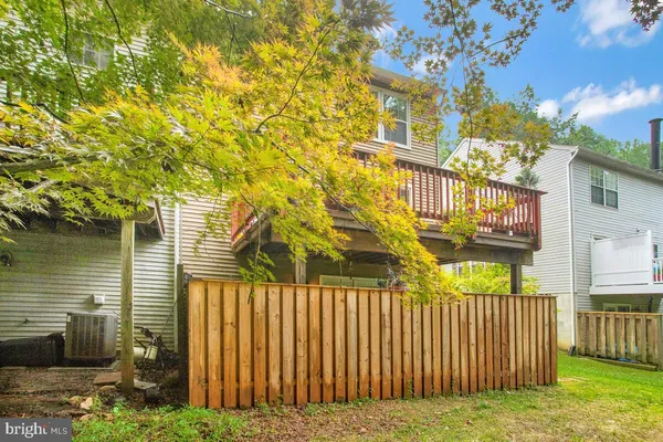a view of a pathway of a house with wooden fence