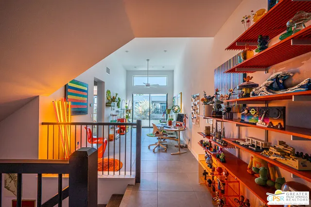 a bedroom with a bed and painting on the wall