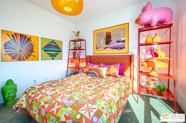 a bedroom with a bed and a painting on the wall