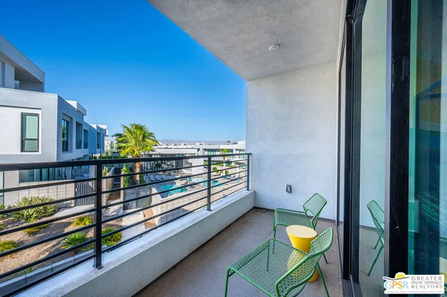 a view of a swimming pool with a chair and a dining table