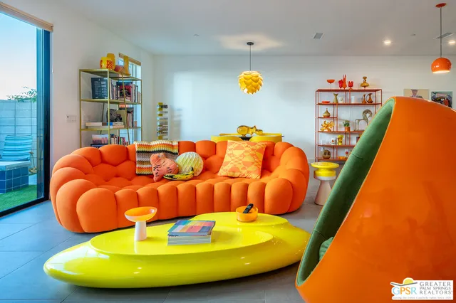 a room with lots of books and a baby crib