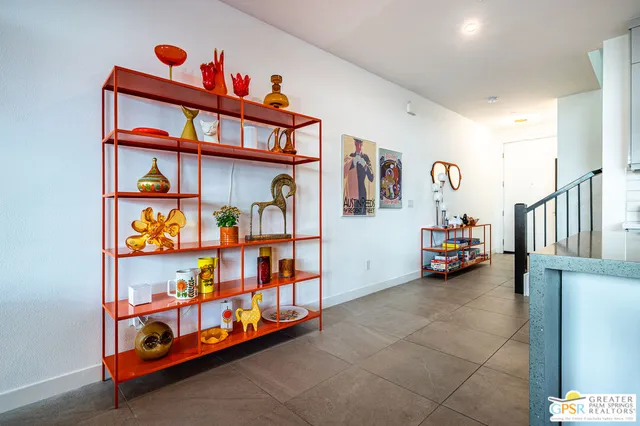 a bedroom with furniture and painting on the wall