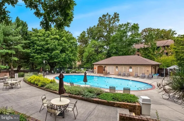 an aerial view of a house with swimming pool garden and patio