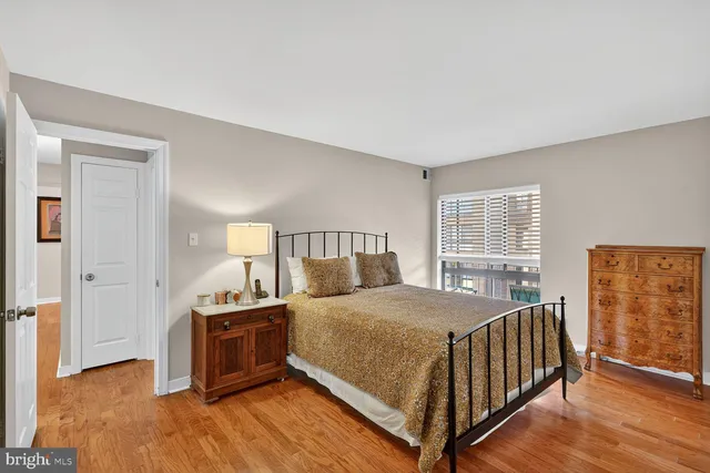 a bedroom with a bed and a night stand