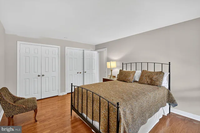 a bedroom with a bed and chair