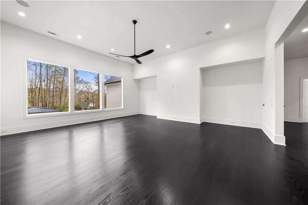 5211 Powers Ferry Road Northwest Sandy Springs, GA 30327 - Photo 85 of 106 an empty room with wooden floor and windows