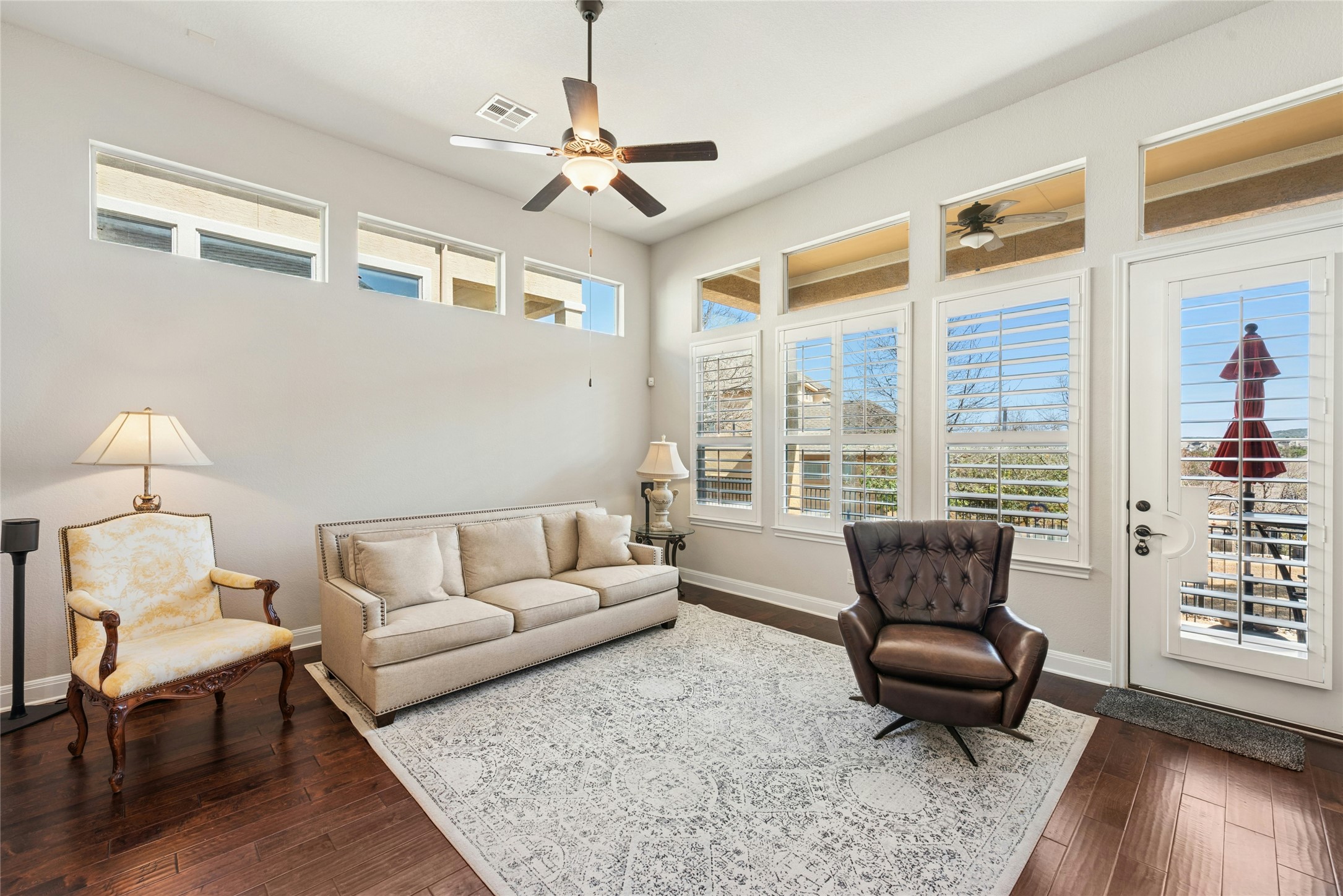 116 Evolutions Path Lakeway, TX 78738 - Photo 12 of 34 Living area with dark wood finished floors and a ceiling fan