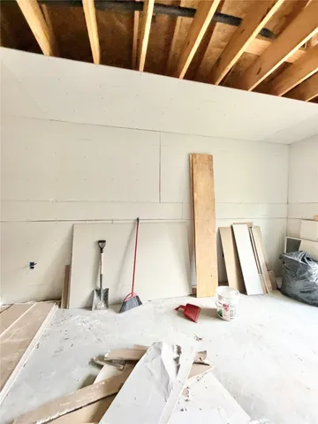 a view of an empty room with a window and fireplace
