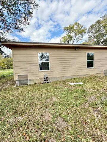 a backyard of a house with table and chairs