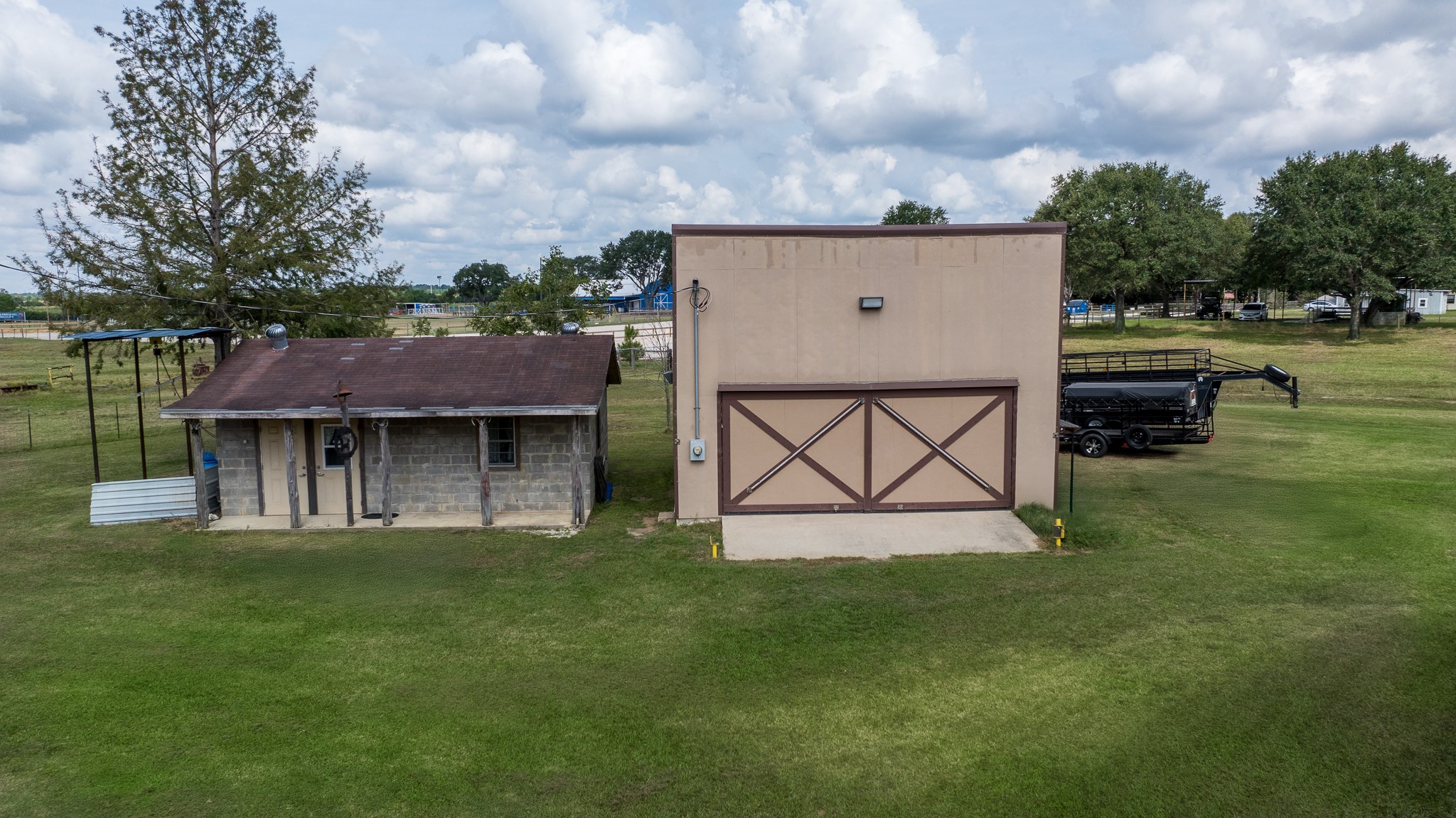 19105 Mueschke Road Tomball, TX 77377 - Photo 14 of 16 a view of a white house next to a yard with a fountain