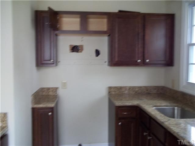 713 Georgetown Road Raleigh, NC 27608 - Photo 7 of 8 a kitchen with a sink and cabinets