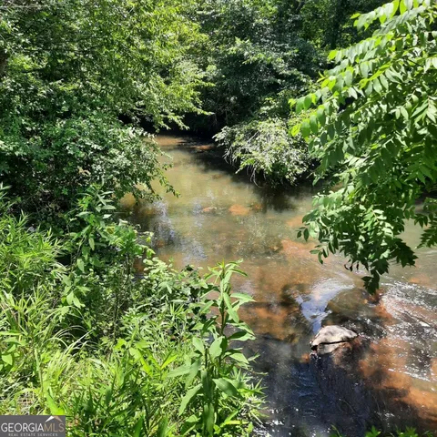 a view of a lake with green space