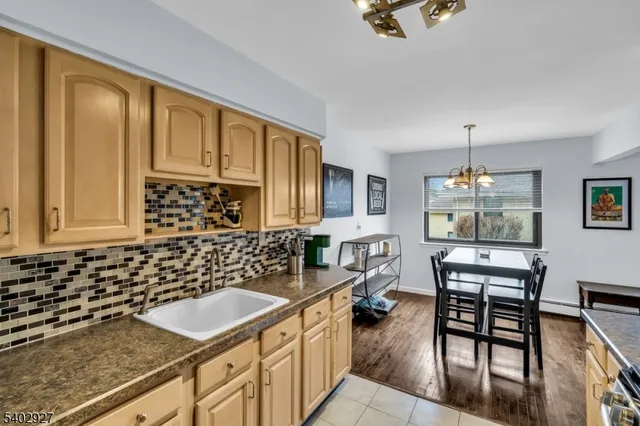 a kitchen with a sink and chairs