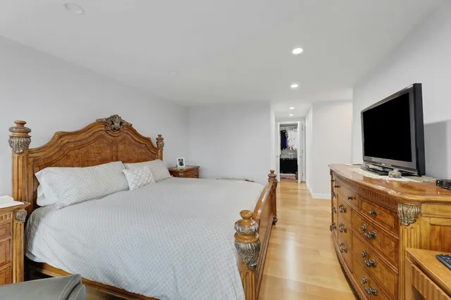 a bedroom with a bed and a flat screen tv