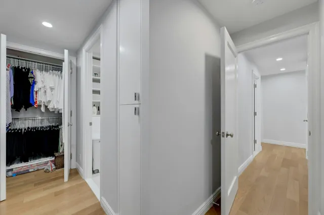 a view of a hallway with bathroom