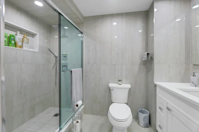 a bathroom with a toilet a sink and shower
