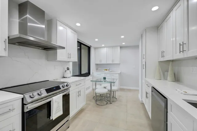 a kitchen with a stove a sink and a refrigerator