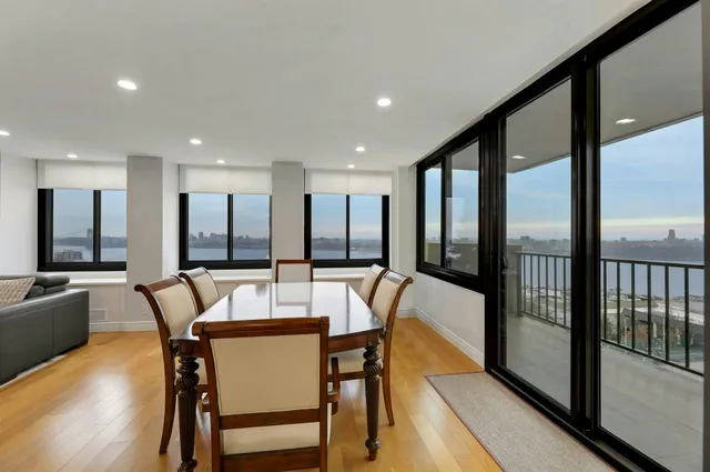 a dining area with furniture and a large window