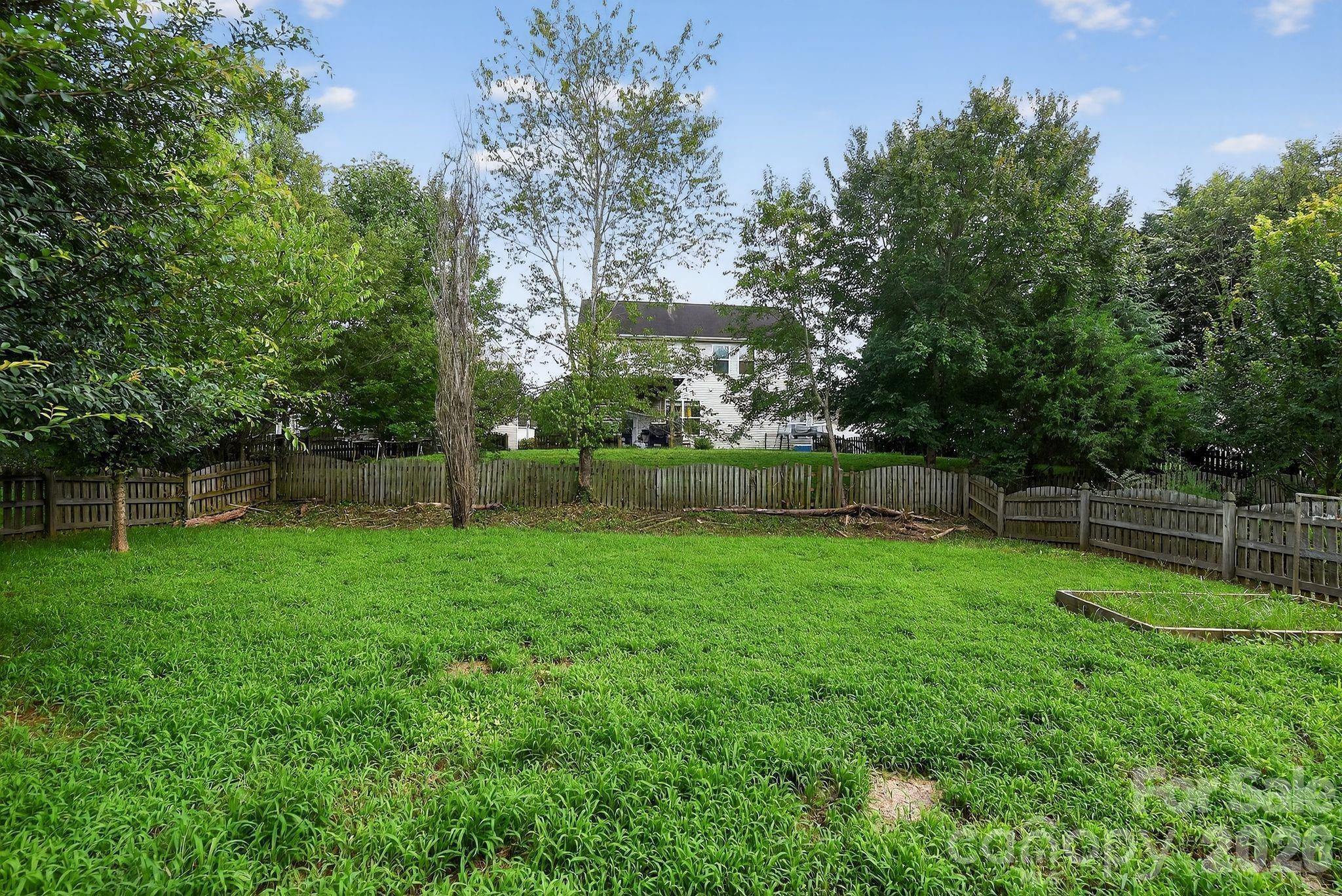 3114 Less Traveled Trail Indian Trail, NC 28079 - Photo 12 of 37 a view of a backyard with a garden