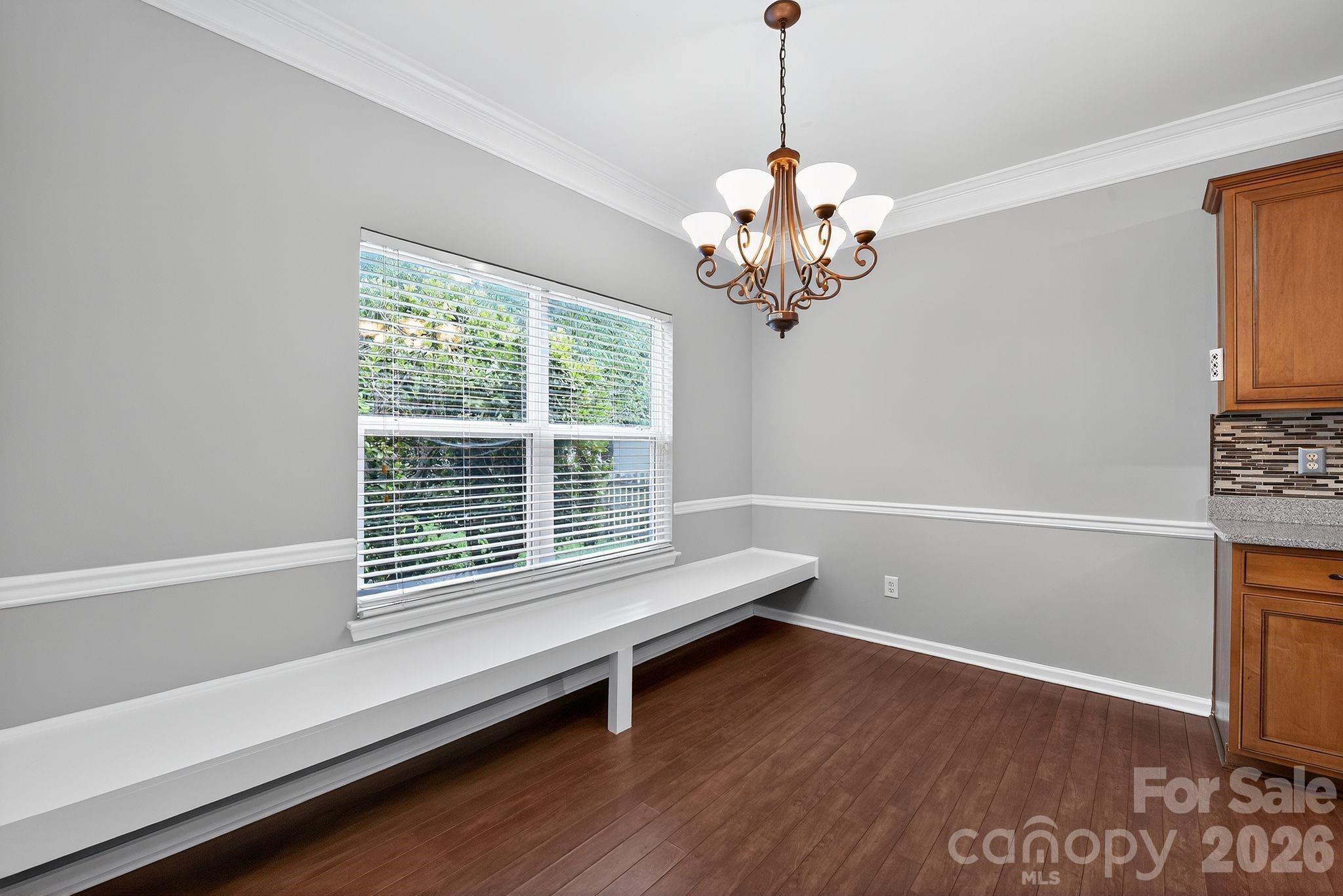3114 Less Traveled Trail Indian Trail, NC 28079 - Photo 20 of 37 a dining room with wooden floor and a chandelier