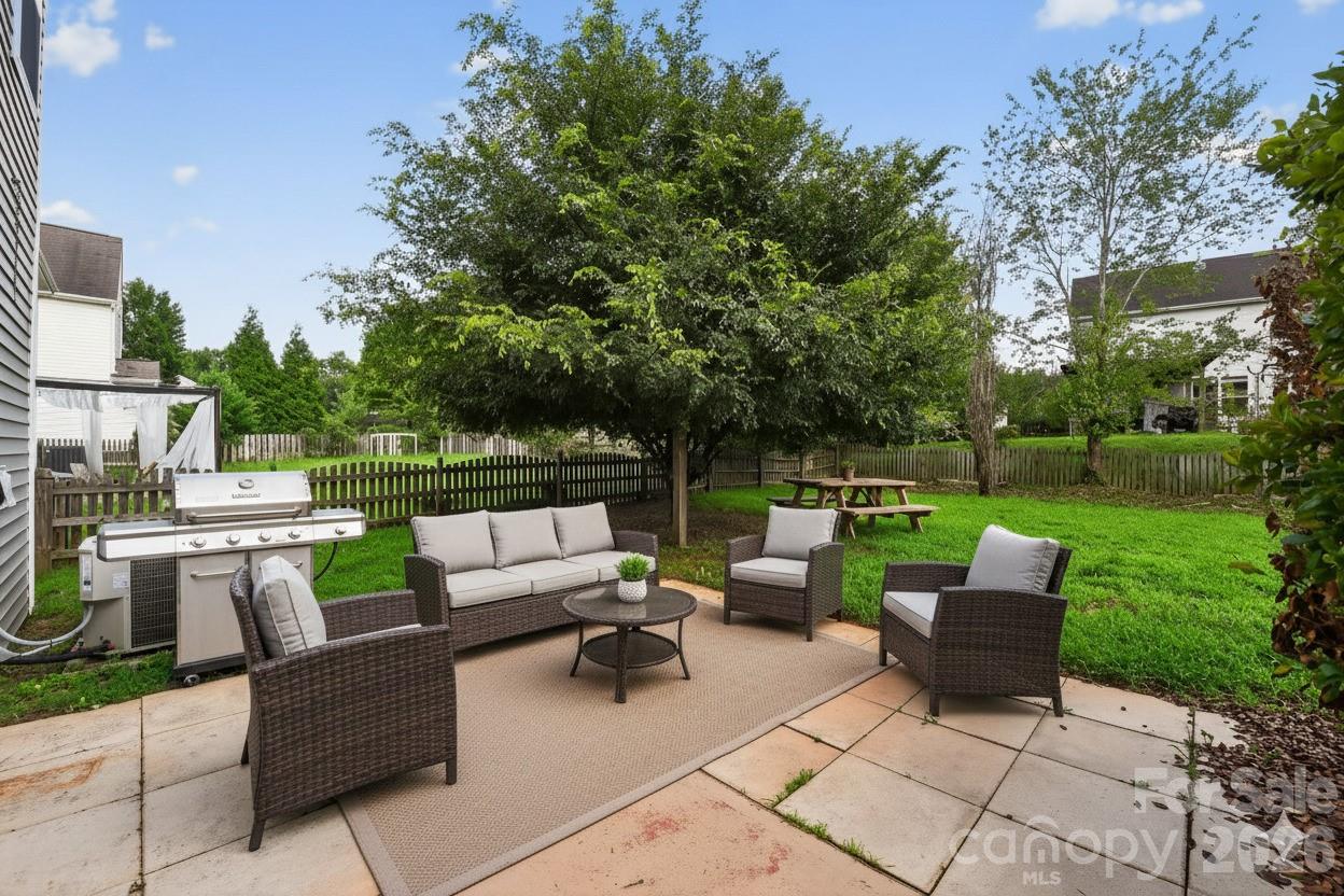 3114 Less Traveled Trail Indian Trail, NC 28079 - Photo 2 of 37 a view of a patio with couches potted plants and a big yard