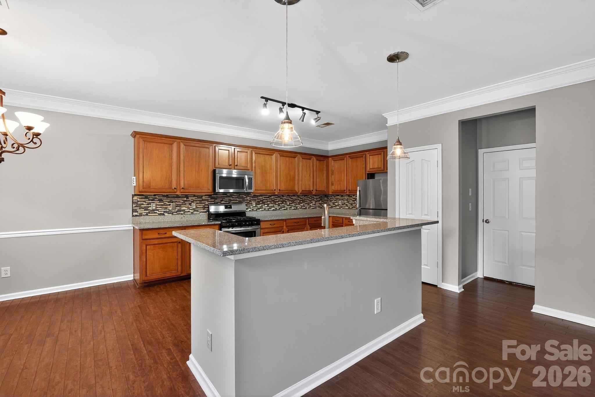 3114 Less Traveled Trail Indian Trail, NC 28079 - Photo 22 of 37 a view of kitchen with stainless steel appliances granite countertop a stove and a refrigerator