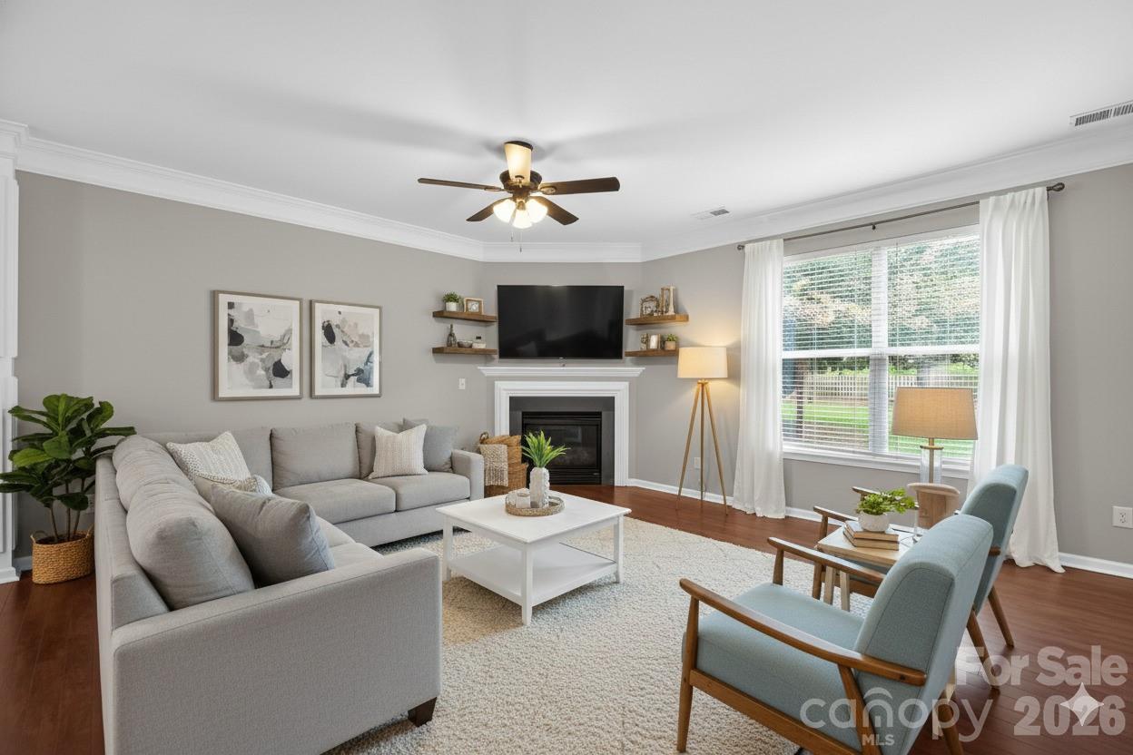 3114 Less Traveled Trail Indian Trail, NC 28079 - Photo 3 of 37 a living room with furniture a fireplace and a large window