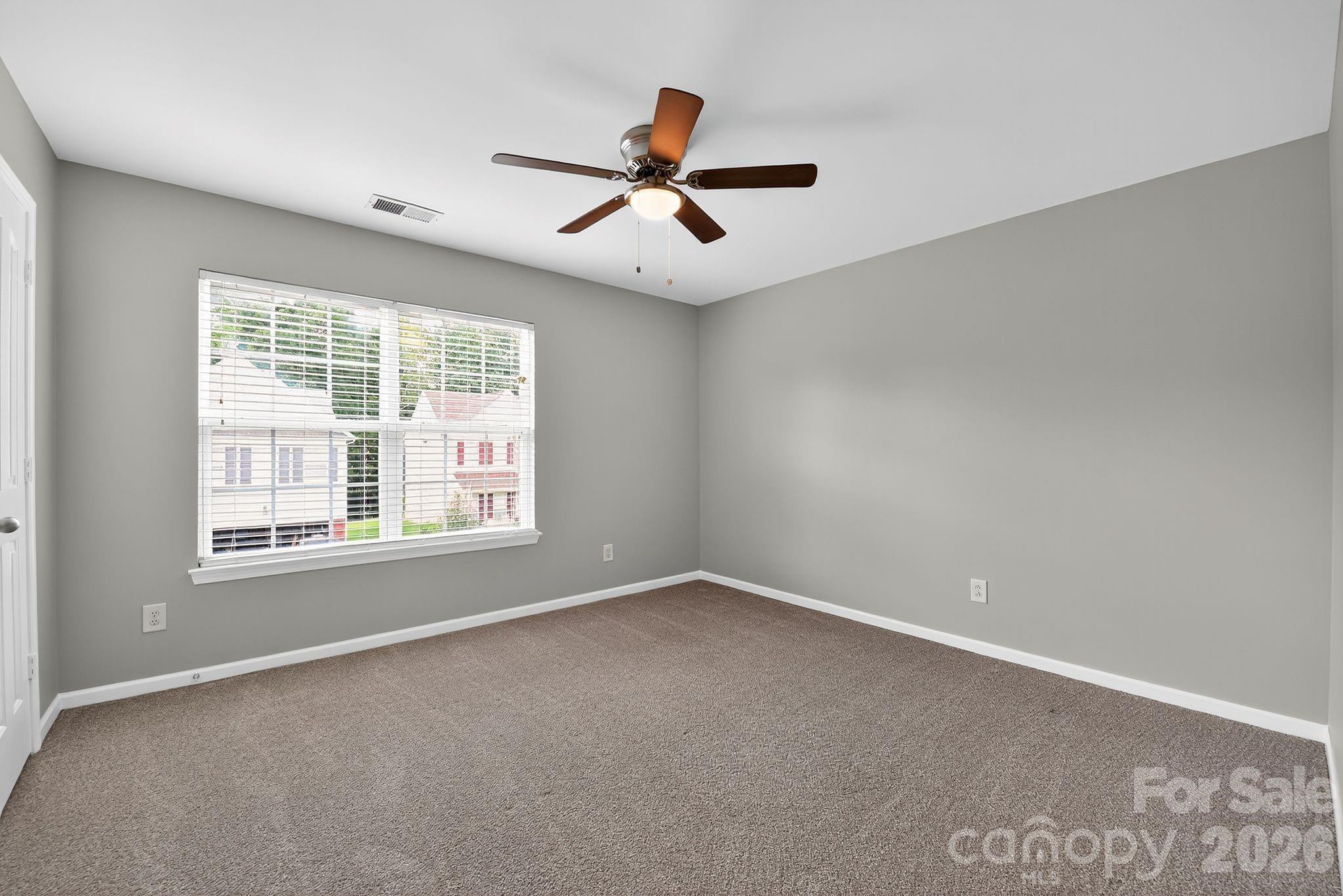 3114 Less Traveled Trail Indian Trail, NC 28079 - Photo 31 of 37 an empty room with ceiling fan and windows