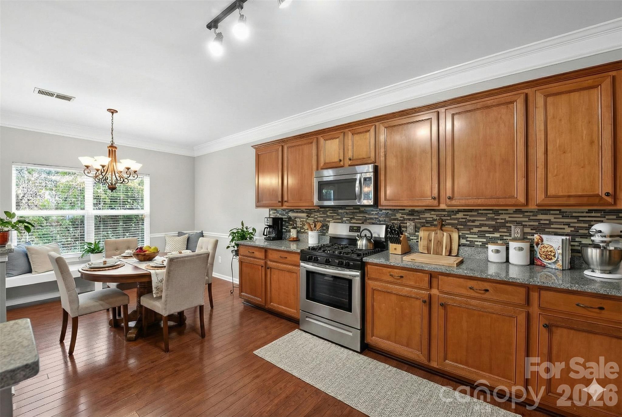 3114 Less Traveled Trail Indian Trail, NC 28079 - Photo 4 of 37 a kitchen with stainless steel appliances granite countertop sink stove top oven and cabinets