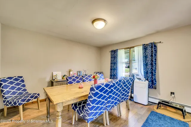 a view of a dining room with furniture and wooden floor