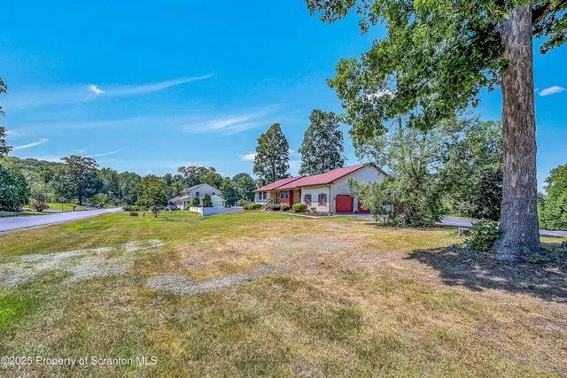 a view of a house with pool and a yard
