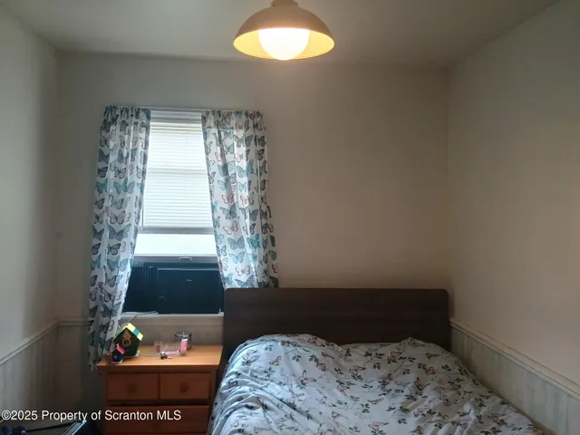 a spacious bedroom with a bed and a couch