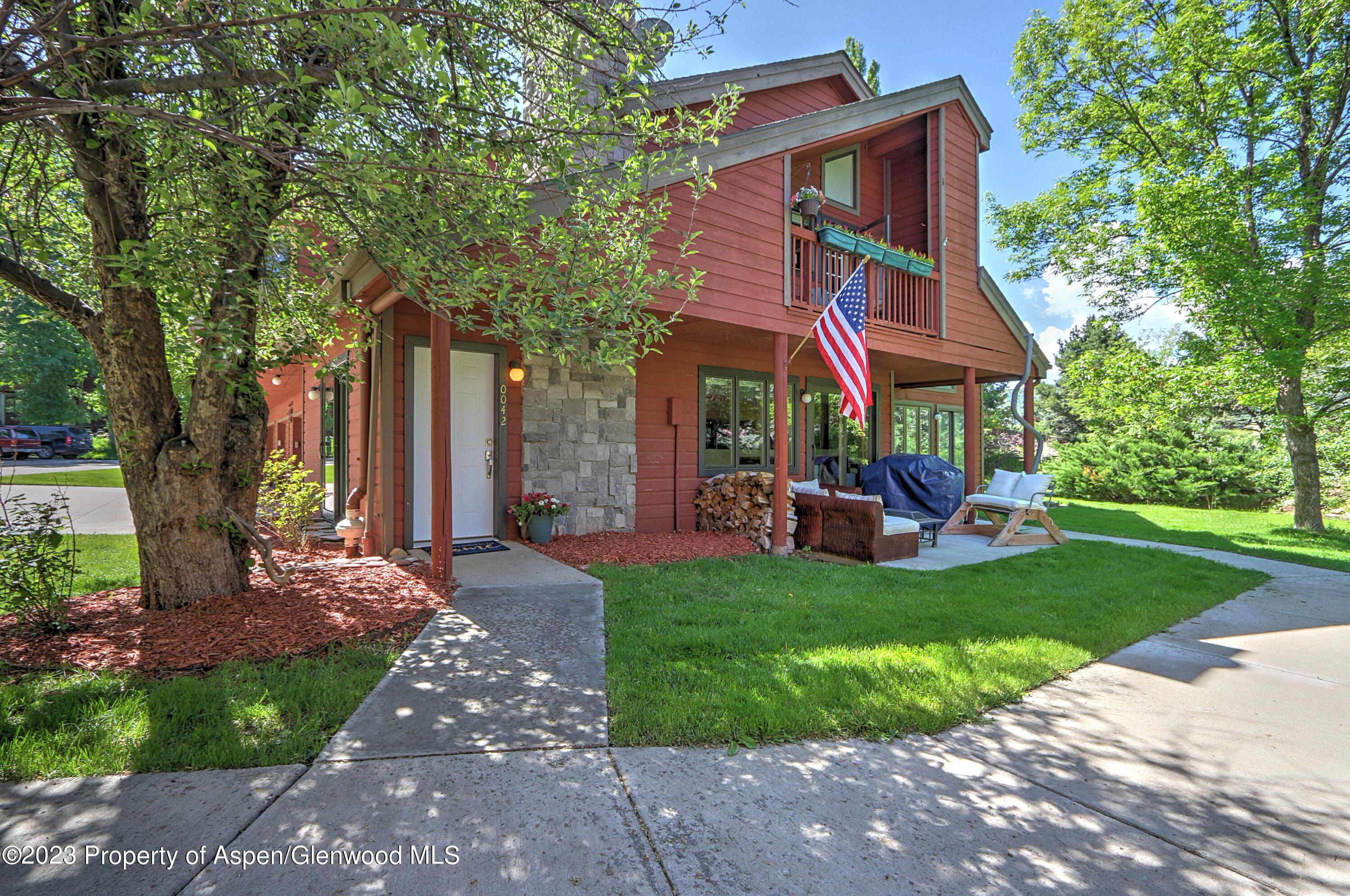 a view of a house with a yard porch and sitting area