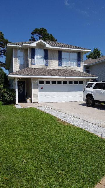 111 Defiance Drive Destin, FL 32541 - Photo 1 of 1 a car parked in front of a house with a yard