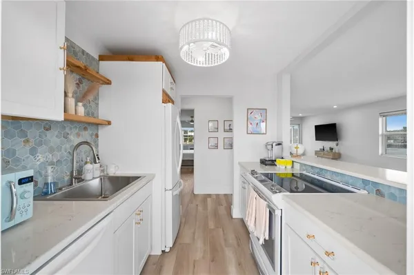 a kitchen with a sink stove and refrigerator